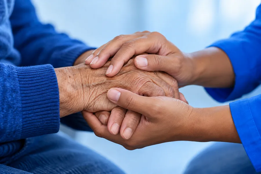 Mãos de duas gerações em um gesto de cuidado